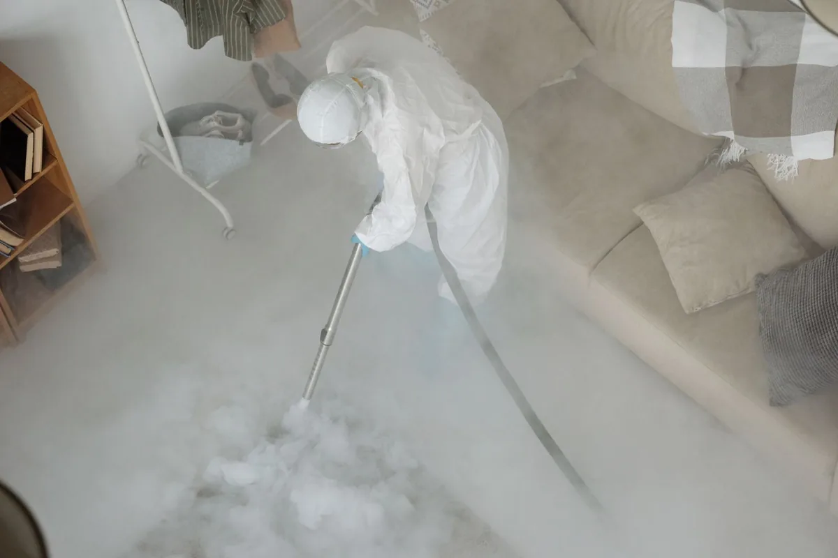 Biohazard cleanup technician in protective equipment, Hopwood, PA